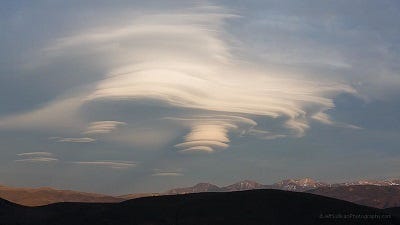 Lenticular clouds resembling UFOs in the sky