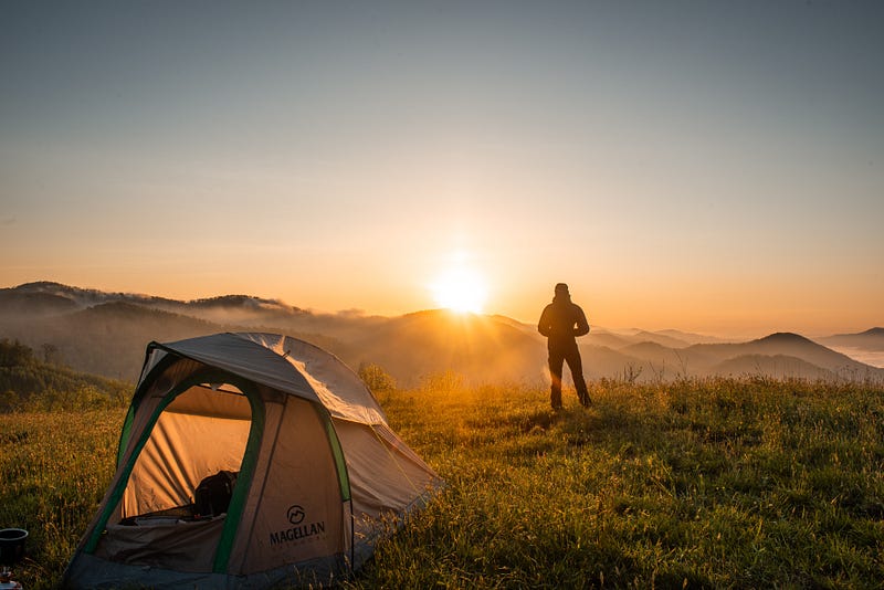 Person enjoying nature near a camping site