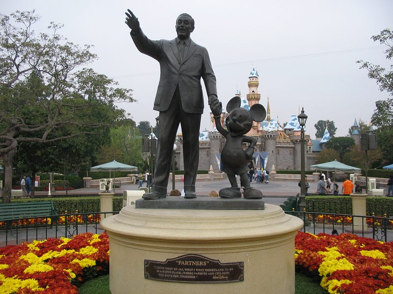 Cartoon representation of Walt Disney with Mickey Mouse