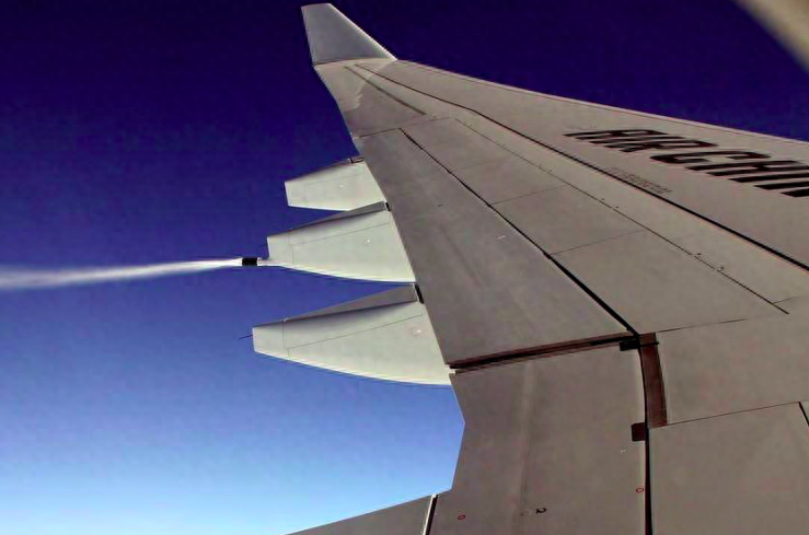 Jet aircraft releasing fuel mid-air