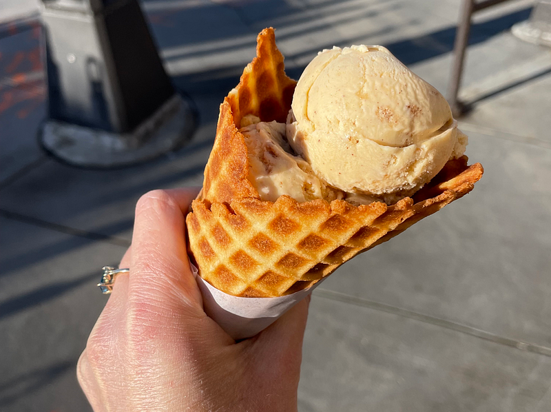 Author holding a waffle cone from her favorite local ice cream shop.