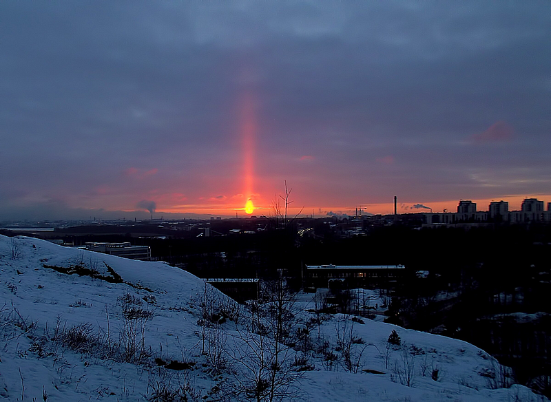 Mysterious pillars of light above the sunset