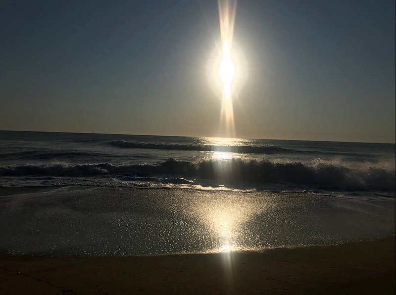 Sunlight pillars captured over the ocean in Virginia, USA